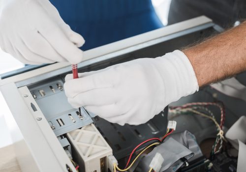 close-up-male-technician-hand-wearing-gloves-repairing-computer