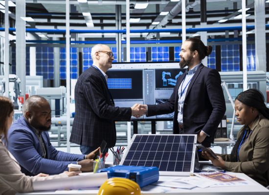 Industrial plant shareholders doing handshake, meeting to conduct research on investment opportunities. Factory shareholders shaking hands, greeting each other, doing competitor analysis